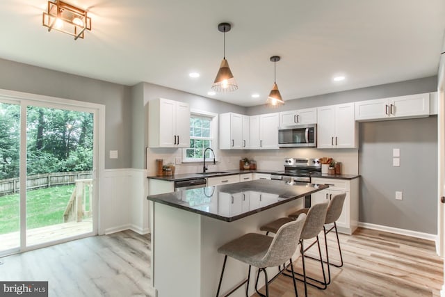 128 Azalea Dr, Hershey, PA 17033 - kitchen featuring stainless steel appliances, dark countertops, white cabinets, light wood-style floors, and recessed lighting