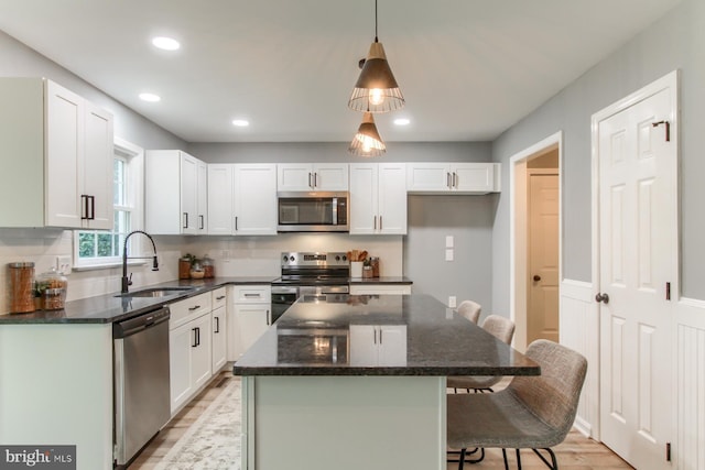 128 Azalea Dr, Hershey, PA 17033 - kitchen featuring stainless steel appliances, light wood finished floors, a breakfast bar, backsplash, and recessed lighting