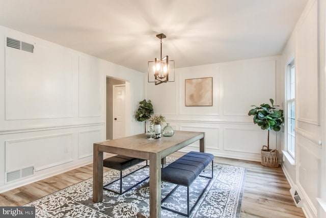 128 Azalea Dr, Hershey, PA 17033 - dining area featuring a decorative wall, a chandelier, and light wood finished floors