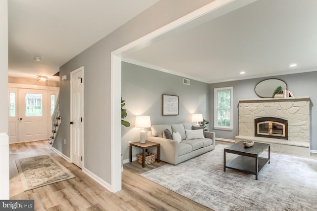128 Azalea Dr, Hershey, PA 17033 - living area with wood finished floors, a stone fireplace, crown molding, and recessed lighting