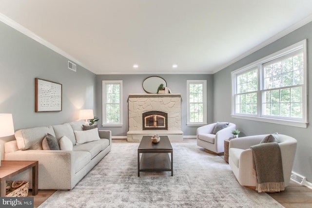 128 Azalea Dr, Hershey, PA 17033 - living room with crown molding, recessed lighting, a stone fireplace, and wood finished floors