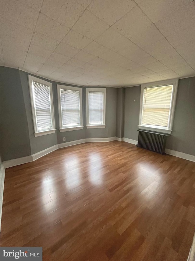 723 N Broad St, Woodbury, NJ 08096 - spare room with radiator heating unit and wood finished floors