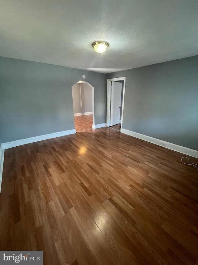 723 N Broad St, Woodbury, NJ 08096 - empty room with wood finished floors and arched walkways