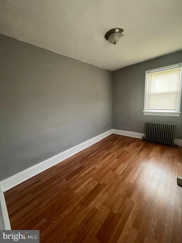 723 N Broad St, Woodbury, NJ 08096 - unfurnished room featuring radiator and wood finished floors