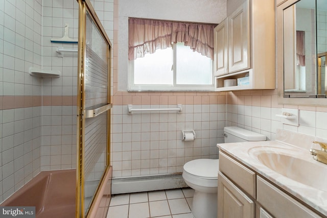 1402 Lehigh St, Allentown, PA 18103 - bathroom featuring tile patterned flooring, baseboard heating, vanity, enclosed tub / shower combo, and tile walls