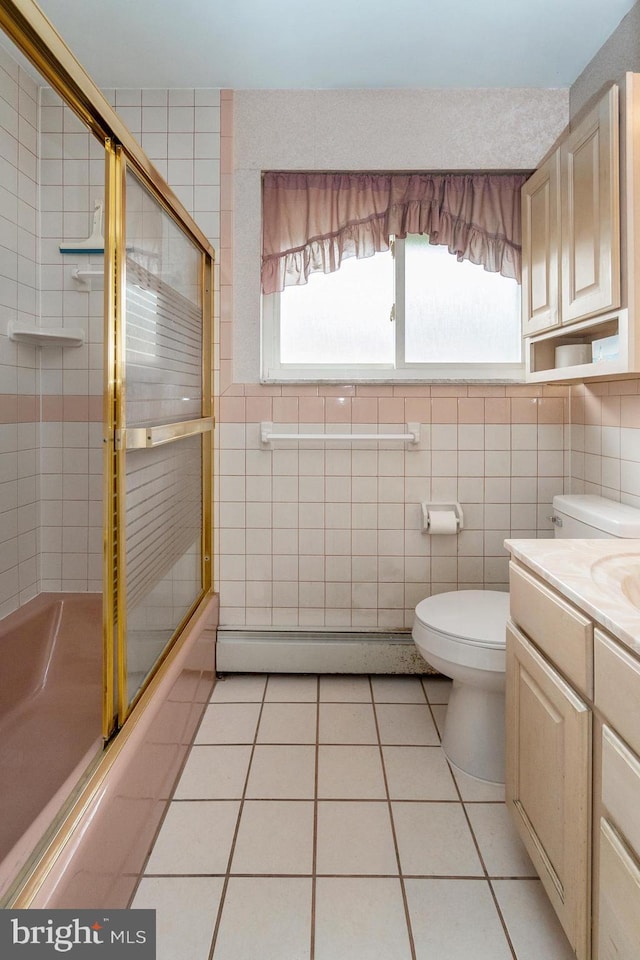 1402 Lehigh St, Allentown, PA 18103 - full bathroom with a baseboard radiator, tile patterned floors, tile walls, vanity, and enclosed tub / shower combo