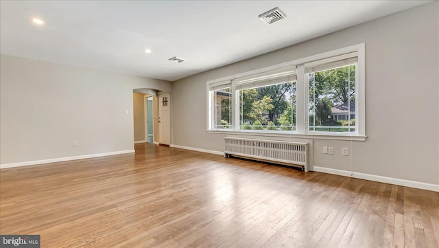 2705 W Gordon, Allentown, PA 18104 - empty room featuring radiator heating unit, hardwood / wood-style floors, arched walkways, and recessed lighting