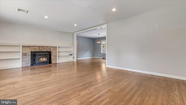 2705 W Gordon, Allentown, PA 18104 - unfurnished living room with wood finished floors, recessed lighting, a tiled fireplace, and built in features