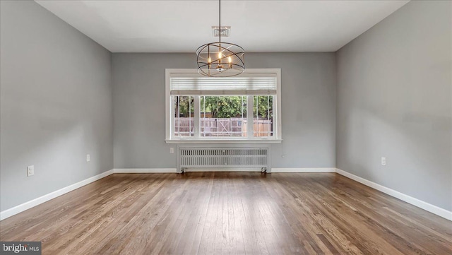2705 W Gordon, Allentown, PA 18104 - empty room featuring radiator, wood finished floors, and a chandelier