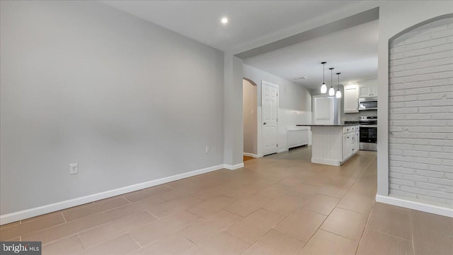 2705 W Gordon, Allentown, PA 18104 - kitchen featuring stainless steel appliances, white cabinetry, dark countertops, a kitchen island, and open floor plan