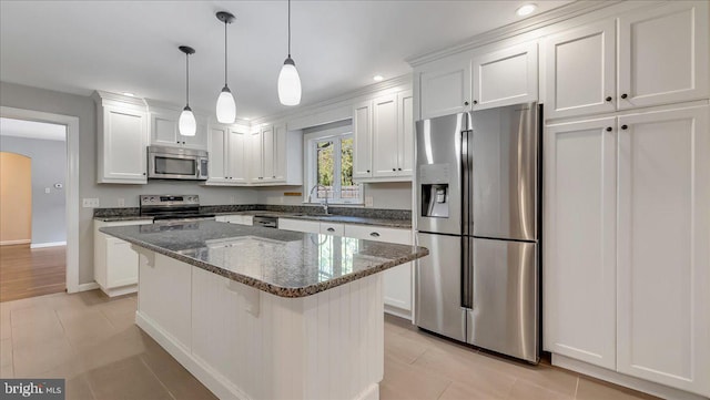 2705 W Gordon, Allentown, PA 18104 - kitchen featuring appliances with stainless steel finishes, white cabinets, a center island, dark stone counters, and hanging light fixtures