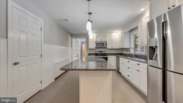 2705 W Gordon, Allentown, PA 18104 - kitchen featuring stainless steel appliances, white cabinetry, a center island, dark stone countertops, and pendant lighting
