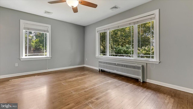 2705 W Gordon, Allentown, PA 18104 - spare room featuring radiator heating unit, healthy amount of natural light, hardwood / wood-style flooring, and ceiling fan