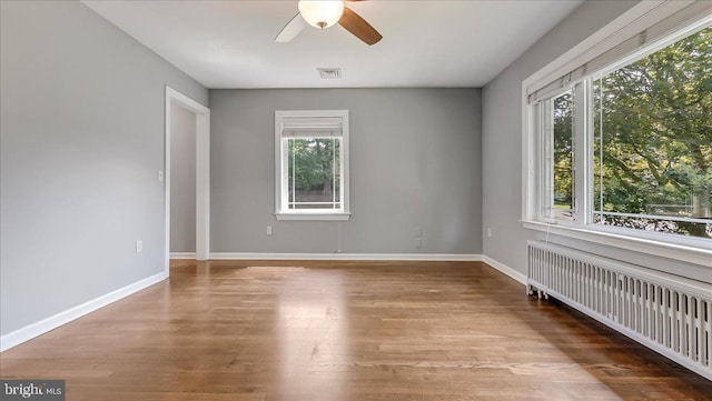 2705 W Gordon, Allentown, PA 18104 - unfurnished room featuring radiator, healthy amount of natural light, ceiling fan, and wood finished floors