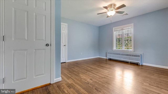 2705 W Gordon, Allentown, PA 18104 - unfurnished room with radiator heating unit, wood finished floors, and a ceiling fan