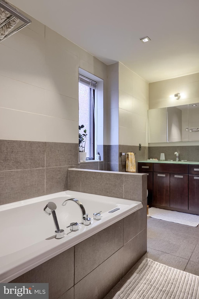 662 W Chestnut St, Lancaster, PA 17603 - full bathroom with vanity, a bath, tile walls, and backsplash