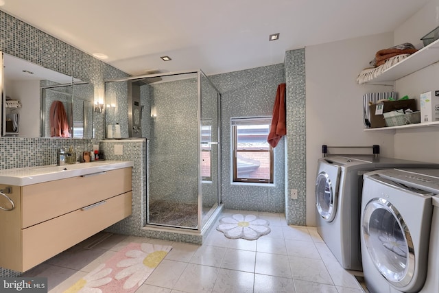 662 W Chestnut St, Lancaster, PA 17603 - bathroom with vanity, a stall shower, separate washer and dryer, tasteful backsplash, and tile patterned floors