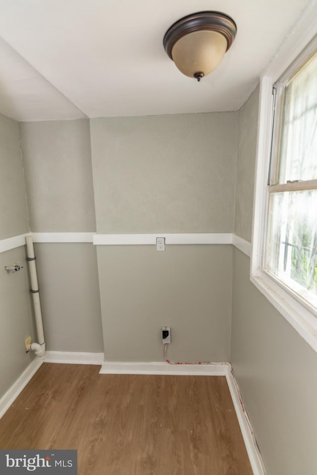 631 Saint Anns Ave, Baltimore, MD 21218 - laundry room featuring wood finished floors and baseboards