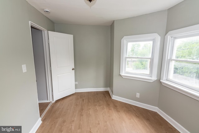 631 Saint Anns Ave, Baltimore, MD 21218 - spare room with light wood-style flooring and a smoke detector