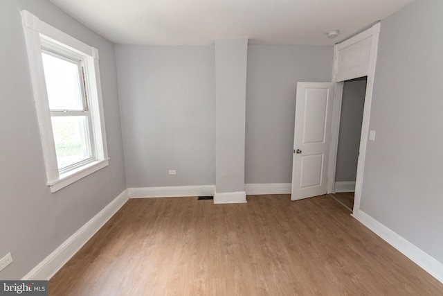 631 Saint Anns Ave, Baltimore, MD 21218 - spare room with light wood-style flooring and a smoke detector