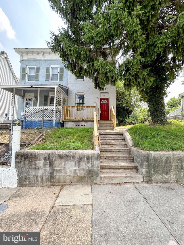 631 Saint Anns Ave, Baltimore, MD 21218 - view of front of home with stucco siding and a porch