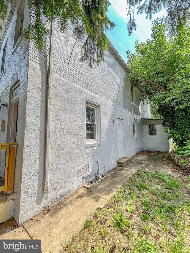 631 Saint Anns Ave, Baltimore, MD 21218 - back of house featuring stucco siding and brick siding