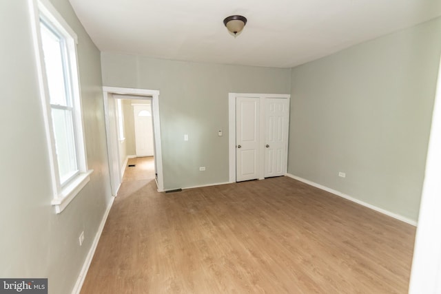 631 Saint Anns Ave, Baltimore, MD 21218 - unfurnished bedroom featuring baseboards and light wood-style floors