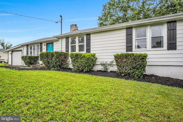 60 Gordon Dr, Carlisle, PA 17013 - view of property exterior featuring an attached garage, a chimney, and a lawn