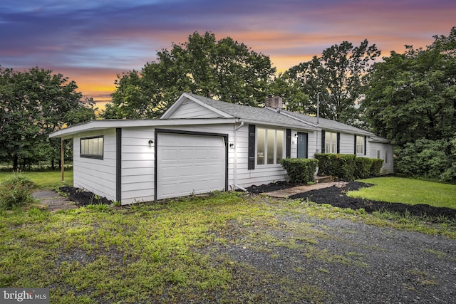 60 Gordon Dr, Carlisle, PA 17013 - view of front of home with a garage, a chimney, a front lawn, roof with shingles, and view of scattered trees