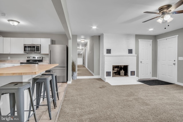 60 Gordon Dr, Carlisle, PA 17013 - kitchen featuring stainless steel appliances, wood counters, a breakfast bar area, white cabinets, and ceiling fan