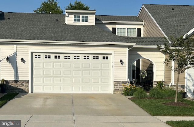 1429 Whispering Woods Rd, Middletown, DE 19709 - view of front facade with driveway, a shingled roof, stone siding, and a garage