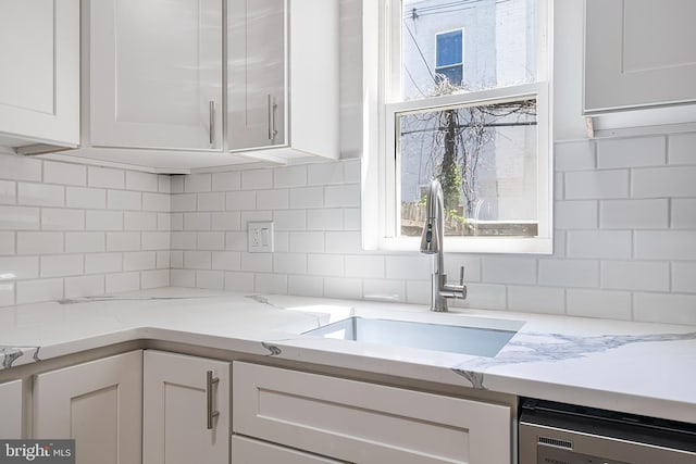 1439 S 28th St, Philadelphia, PA 19146 - kitchen with white cabinetry, dishwashing machine, decorative backsplash, and light stone countertops