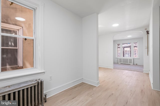 1439 S 28th St, Philadelphia, PA 19146 - corridor featuring radiator, arched walkways, radiator heating unit, wood finished floors, and recessed lighting