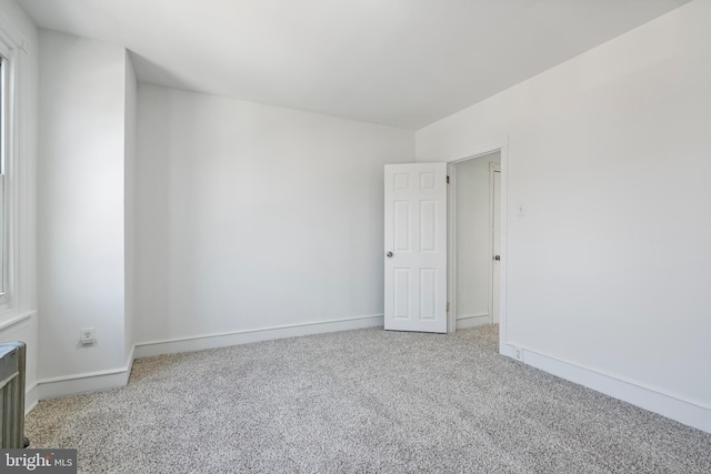 1439 S 28th St, Philadelphia, PA 19146 - carpeted empty room with baseboards and radiator heating unit