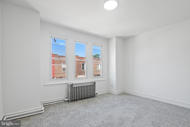 1439 S 28th St, Philadelphia, PA 19146 - carpeted empty room featuring radiator heating unit and baseboards