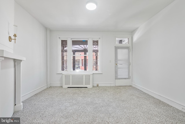 1439 S 28th St, Philadelphia, PA 19146 - unfurnished living room featuring radiator heating unit and carpet floors