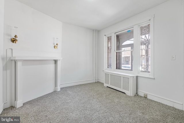 1439 S 28th St, Philadelphia, PA 19146 - carpeted empty room with radiator and baseboards
