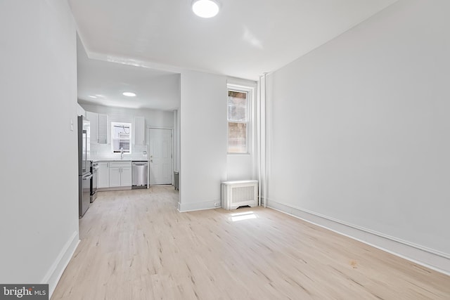 1439 S 28th St, Philadelphia, PA 19146 - unfurnished living room with a sink and light wood-style flooring