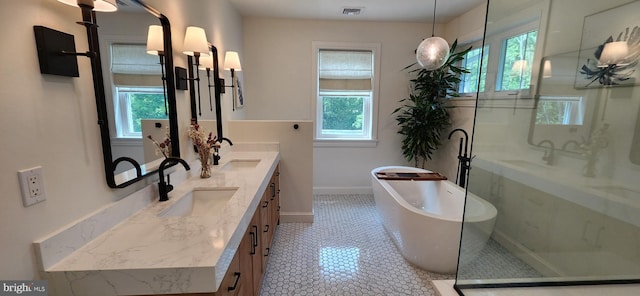 73 Bayberry Rd, Princeton, NJ 08540 - full bathroom with healthy amount of natural light, double vanity, and a freestanding tub