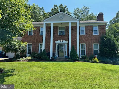2044 Kings House Rd, Silver Spring, MD 20905 - greek revival inspired property with a chimney, a front yard, and brick siding