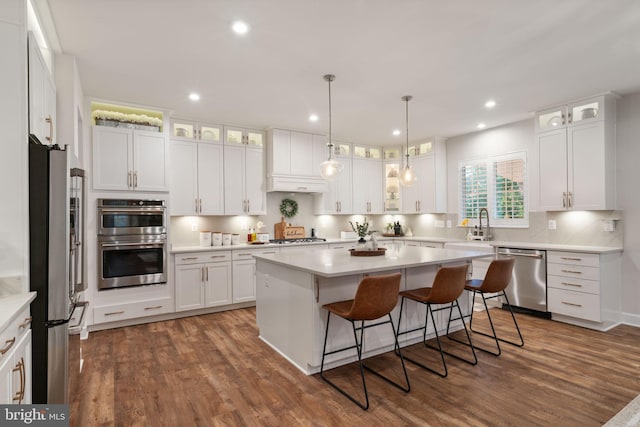 303 Petunia Way, Stafford, VA 22554 - kitchen featuring appliances with stainless steel finishes, a kitchen island, a breakfast bar, white cabinets, and dark wood finished floors
