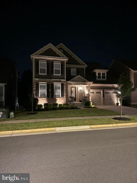 303 Petunia Way, Stafford, VA 22554 - view of front of property with driveway, a garage, stone siding, and a lawn