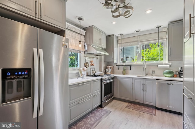 828 Turner Ave, Drexel Hill, PA 19026 - kitchen with appliances with stainless steel finishes, gray cabinets, under cabinet range hood, light wood finished floors, and recessed lighting