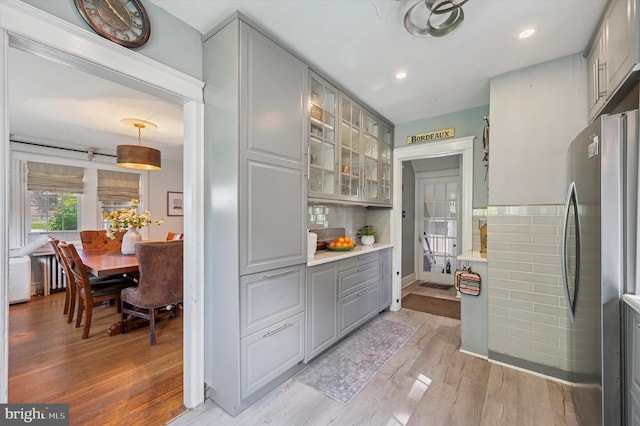 828 Turner Ave, Drexel Hill, PA 19026 - kitchen with freestanding refrigerator, gray cabinetry, light wood-style floors, glass insert cabinets, and recessed lighting