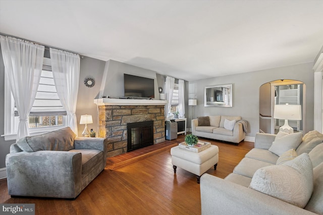 828 Turner Ave, Drexel Hill, PA 19026 - living room featuring wood finished floors, a fireplace, and arched walkways