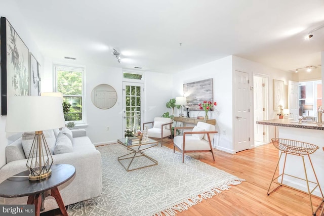 1308 Clifton St NW Unit 118, Washington, DC 20009 - living room featuring light wood-style flooring and baseboards