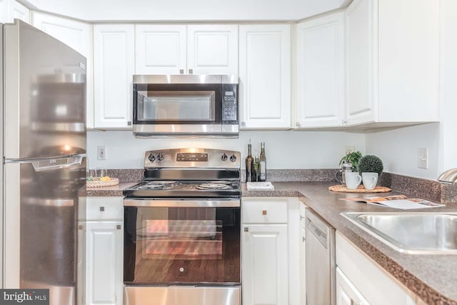 1308 Clifton St NW Unit 118, Washington, DC 20009 - kitchen featuring appliances with stainless steel finishes and white cabinets