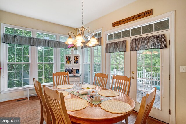 25072 Gazelle Ct, Chantilly, VA 20152 - dining space with a chandelier, plenty of natural light, and wood finished floors