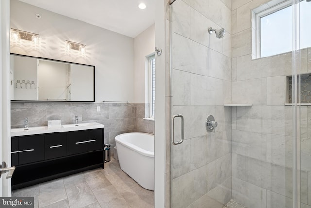 1448 N Myrtlewood St, Philadelphia, PA 19121 - full bath featuring healthy amount of natural light, a stall shower, a freestanding bath, double vanity, and tile walls