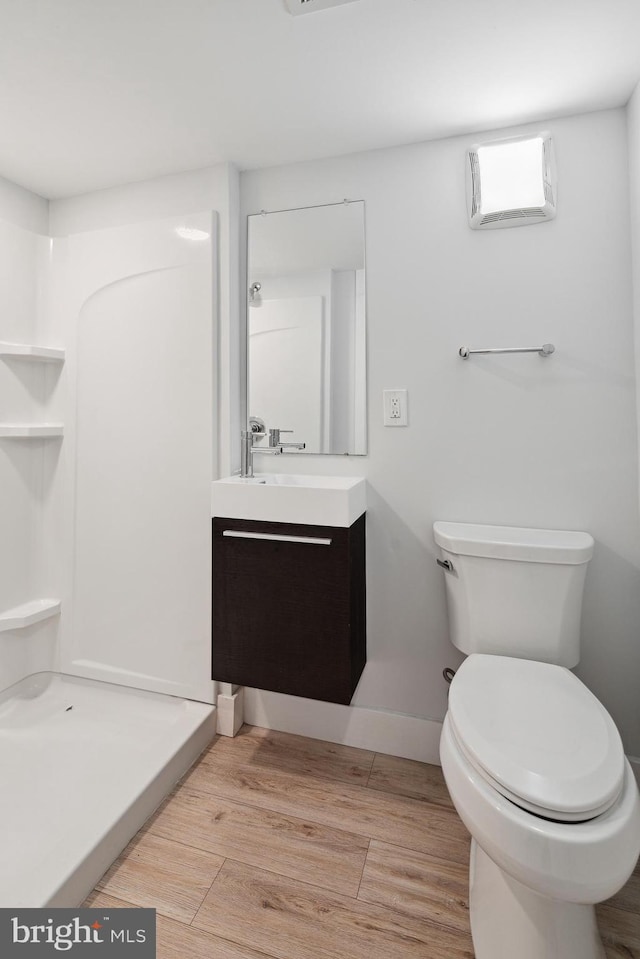 1448 N Myrtlewood St, Philadelphia, PA 19121 - full bathroom with vanity, wood finished floors, and a stall shower